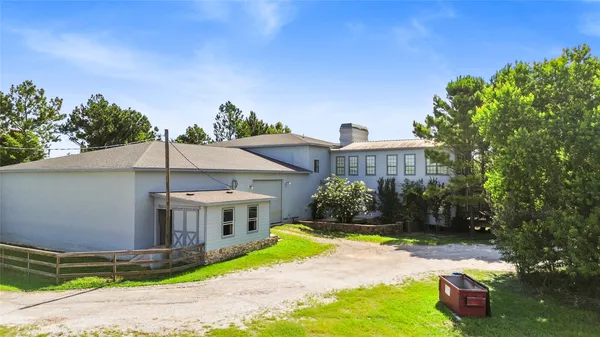 a view of a house with backyard porch and sitting area
