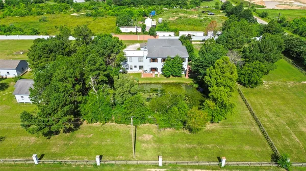 a view of a big yard with large trees