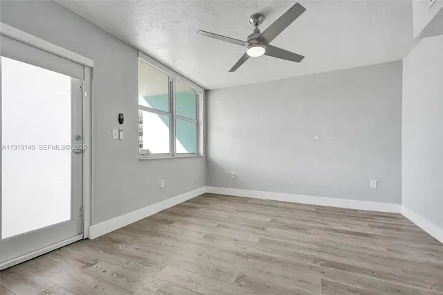 a view of livingroom with hardwood floor and ceiling fan