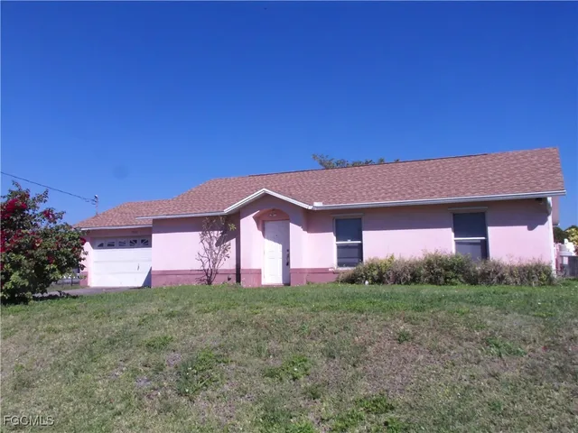 a front view of house with yard and trees