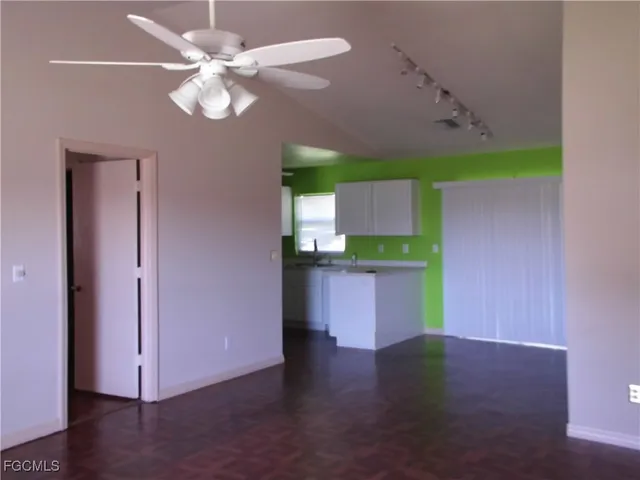 a view of a kitchen with a sink and a workspace