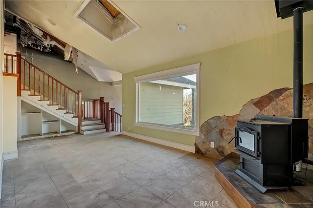 a view of an empty room and kitchen