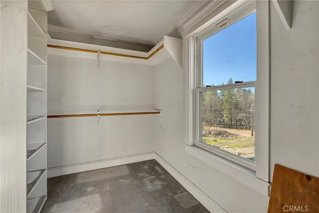 a bedroom with furniture and a window