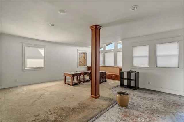 a front view of a house with a yard and mountain view