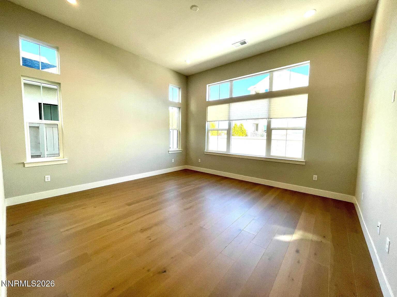 5418 Side Saddle Trail Reno, NV 89511 - Photo 13 of 37 an empty room with wooden floor and windows