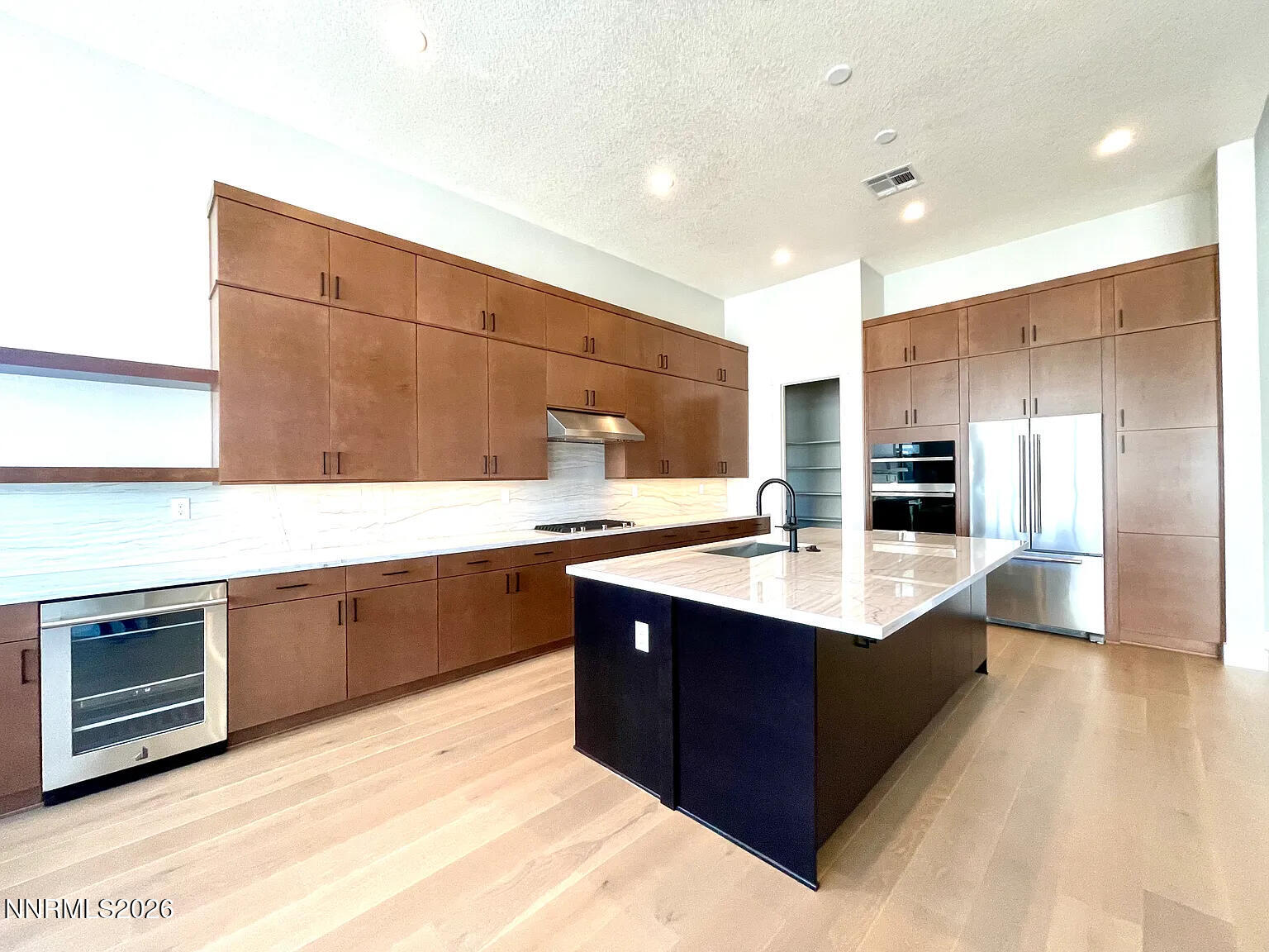 5418 Side Saddle Trail Reno, NV 89511 - Photo 6 of 37 a kitchen with stainless steel appliances kitchen island granite countertop a sink counter space and cabinets