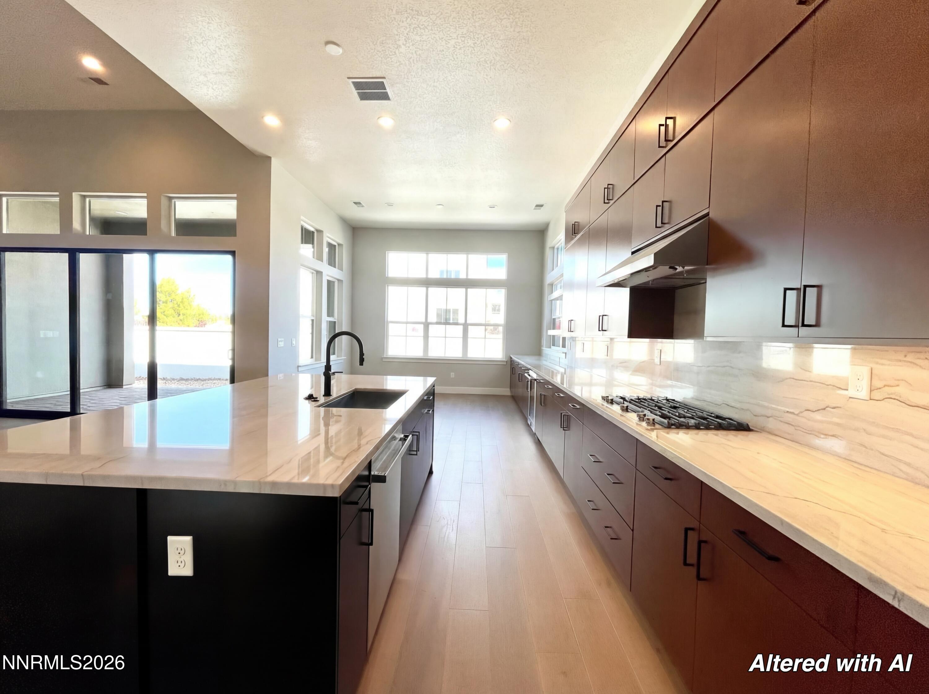 5418 Side Saddle Trail Reno, NV 89511 - Photo 7 of 37 a large kitchen with stainless steel appliances kitchen island granite countertop a large counter top a stove and a sink