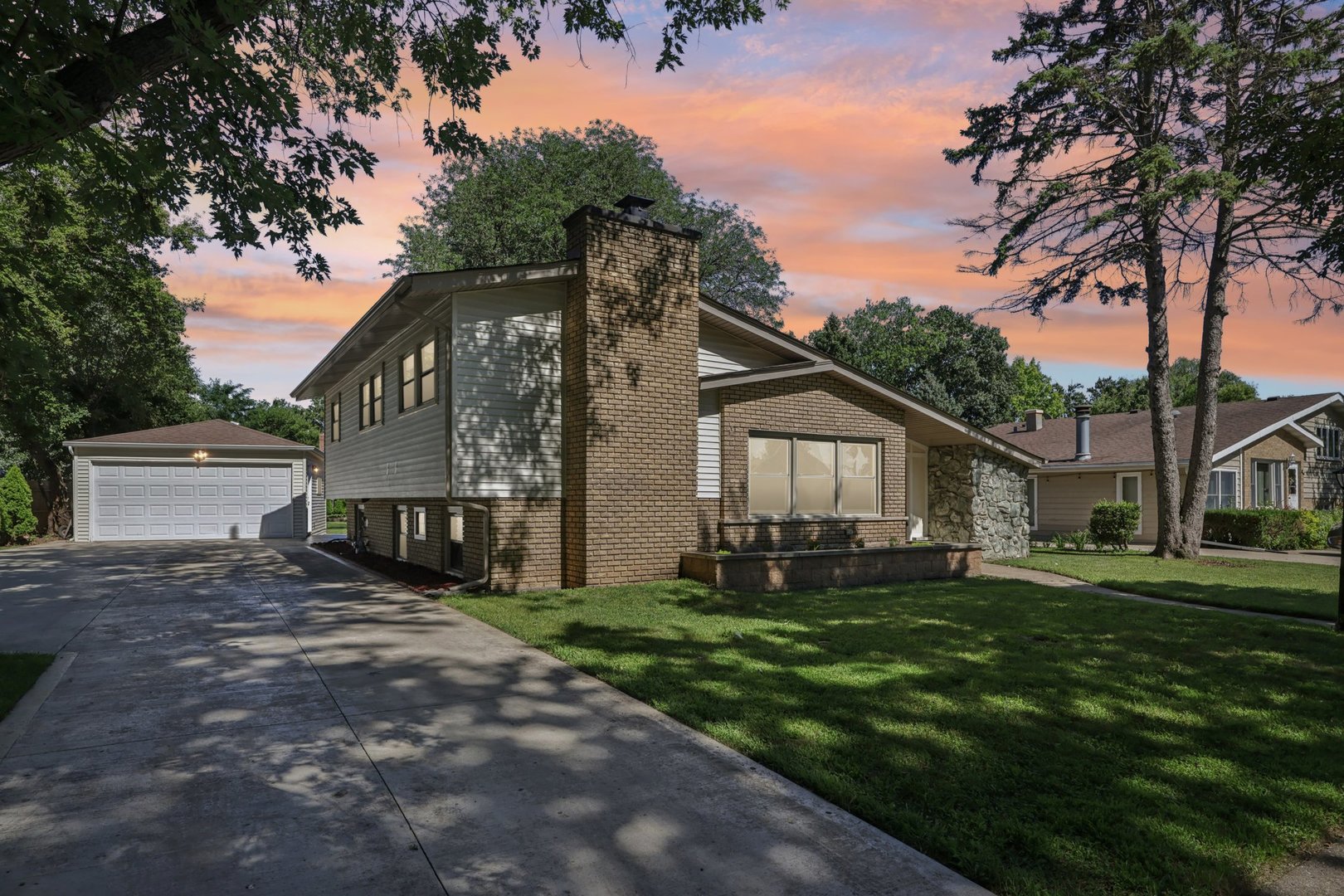 a front view of house with yard and green space