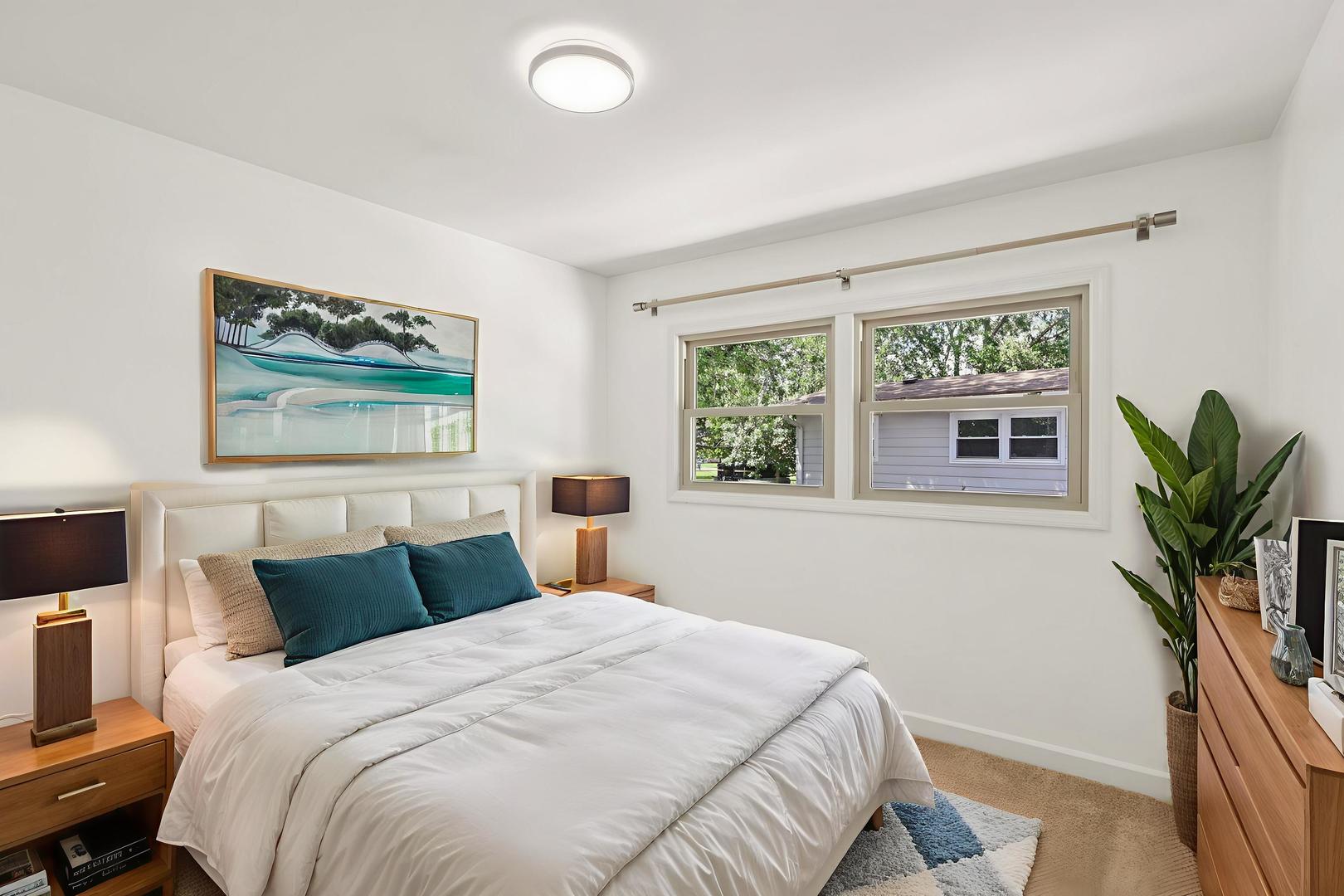 195 7th Street Wheeling, IL 60090 - Photo 17 of 34 a bedroom with a large bed and a potted plant