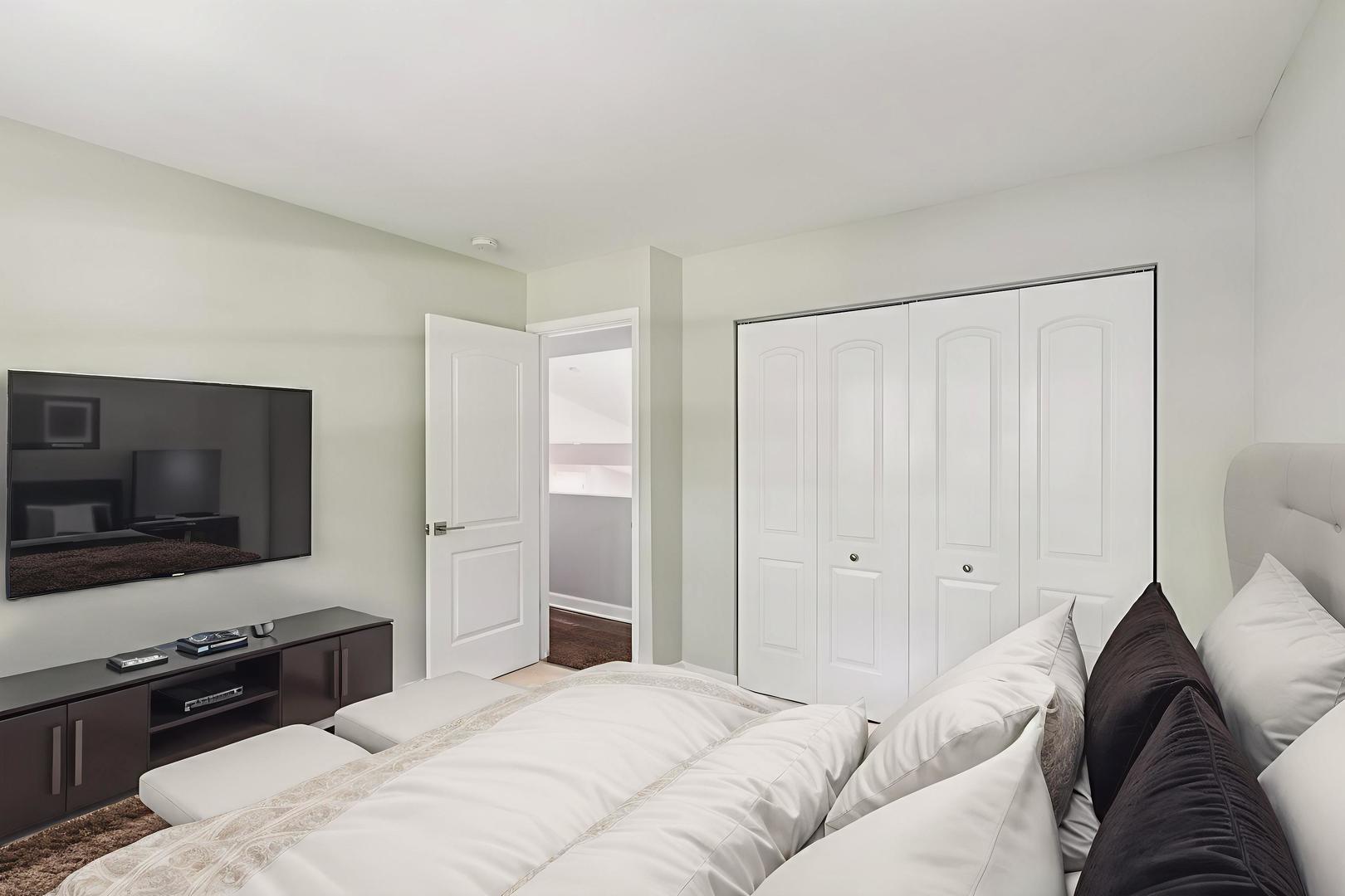 195 7th Street Wheeling, IL 60090 - Photo 19 of 34 a bedroom with a bed and a flat screen tv