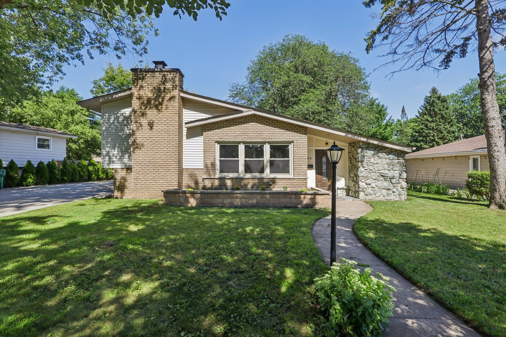 195 7th Street Wheeling, IL 60090 - Photo 2 of 34 a view of a house with a yard and a garden