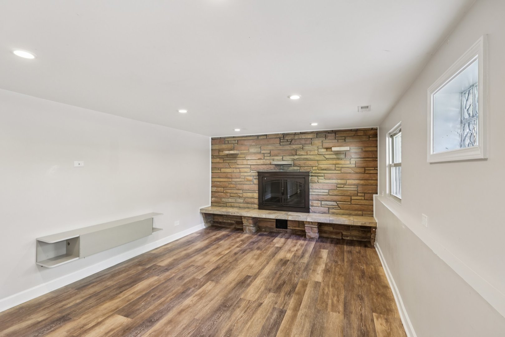 195 7th Street Wheeling, IL 60090 - Photo 22 of 34 a view of empty room with wooden floor and fireplace
