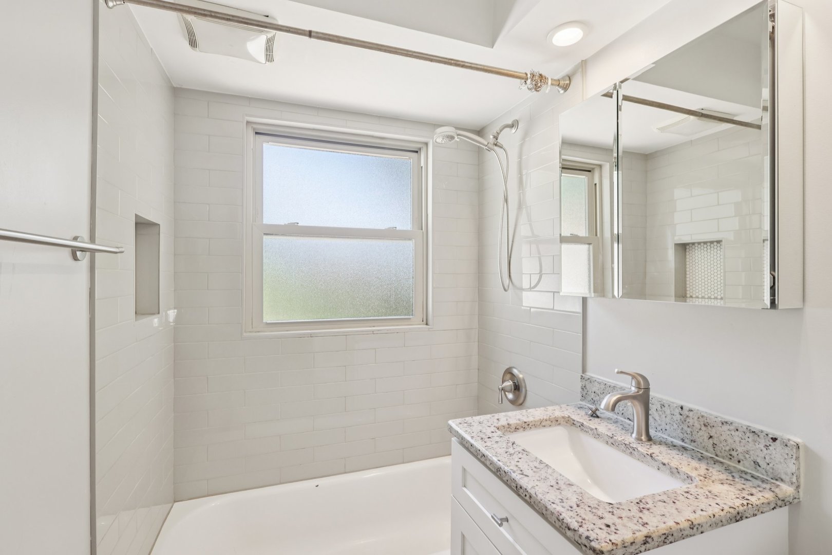 195 7th Street Wheeling, IL 60090 - Photo 26 of 34 a bathroom with a granite countertop sink a mirror and a shower