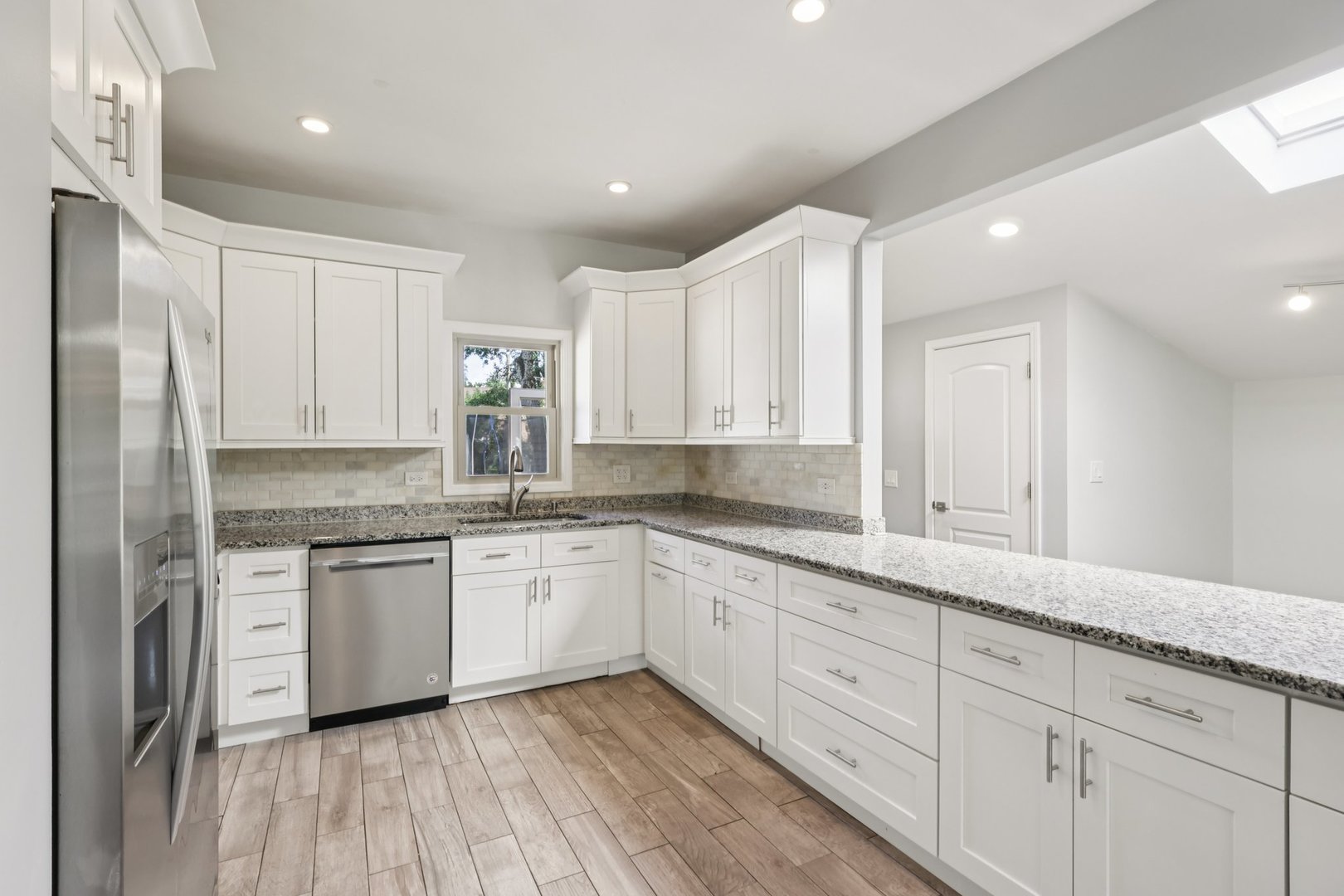 195 7th Street Wheeling, IL 60090 - Photo 10 of 34 a kitchen with granite countertop cabinets stainless steel appliances a sink and a window