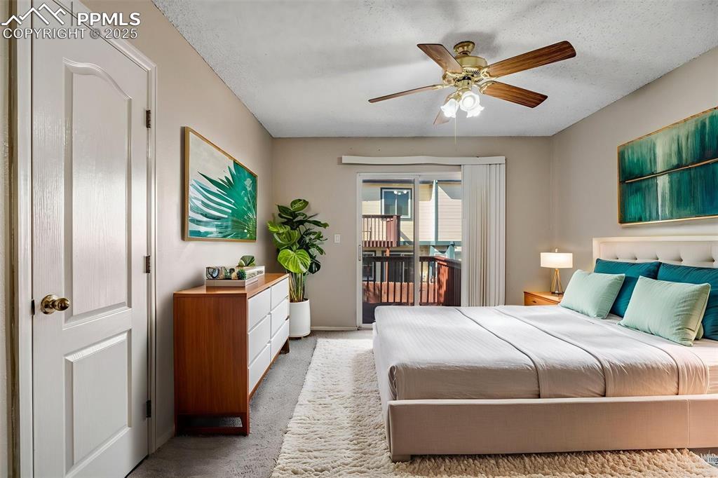 730 Mediterranean Point Colorado Springs, CO 80910 - Photo 12 of 30 a bedroom with a large bed and a chandelier