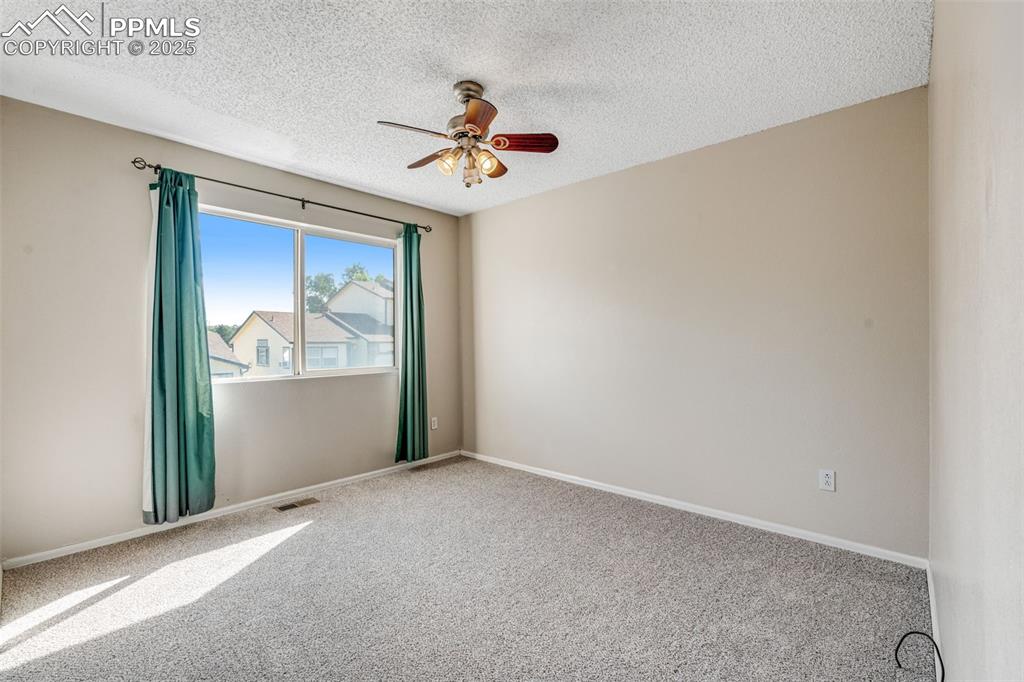 730 Mediterranean Point Colorado Springs, CO 80910 - Photo 17 of 30 an empty room with windows and fan