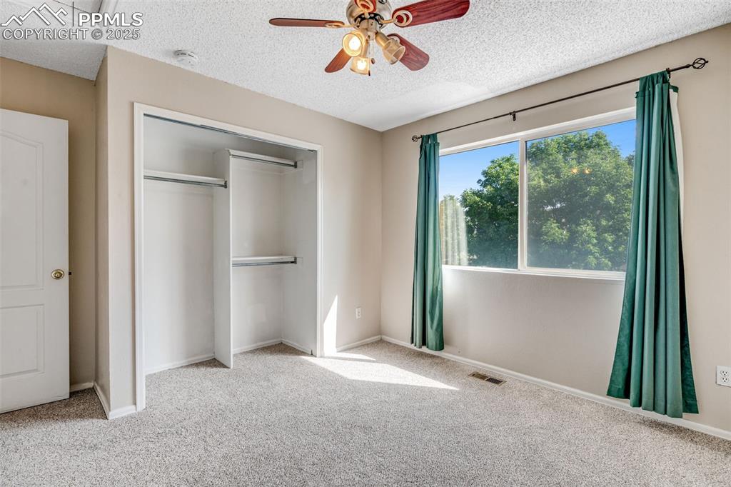 730 Mediterranean Point Colorado Springs, CO 80910 - Photo 18 of 30 an empty room with a window and a ceiling fan