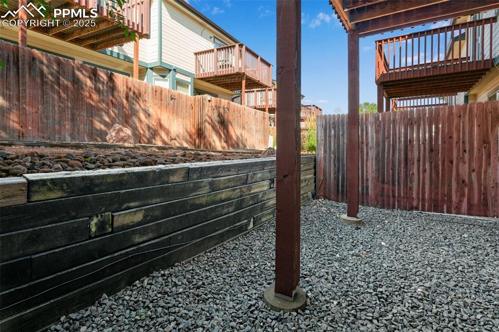730 Mediterranean Point Colorado Springs, CO 80910 - Photo 22 of 30 a view of a house with a wooden fence