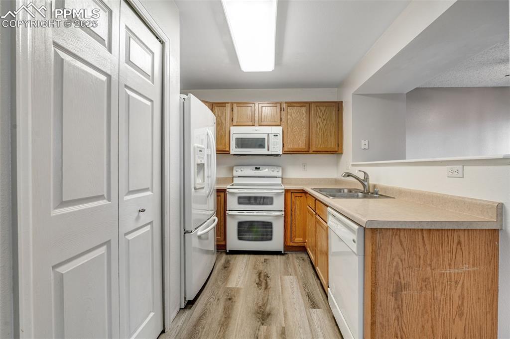 730 Mediterranean Point Colorado Springs, CO 80910 - Photo 3 of 30 a kitchen with a sink stove and refrigerator