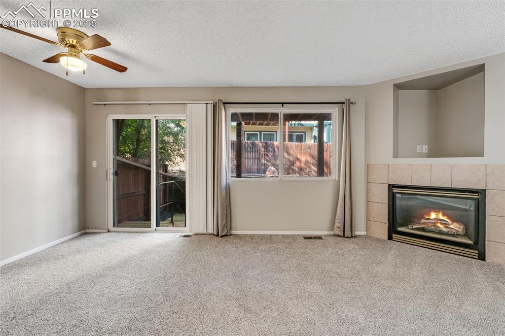 730 Mediterranean Point Colorado Springs, CO 80910 - Photo 5 of 30 a view of an empty room with a fireplace