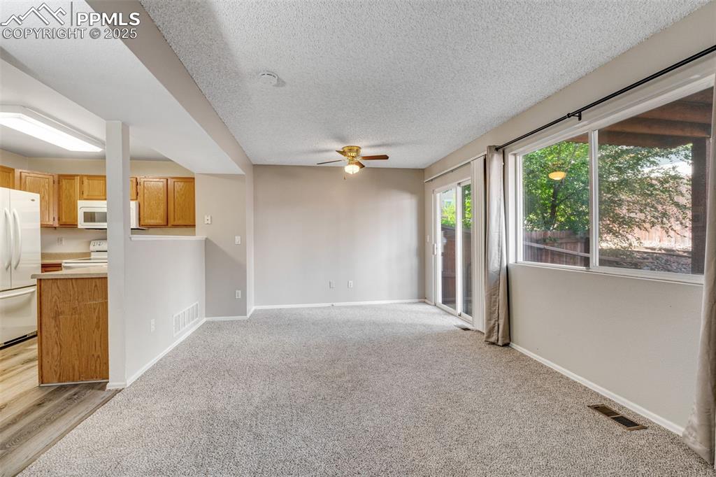 730 Mediterranean Point Colorado Springs, CO 80910 - Photo 6 of 30 a view of a big room with windows and kitchen view