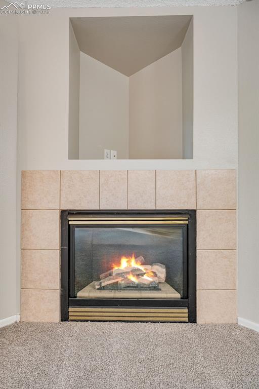 730 Mediterranean Point Colorado Springs, CO 80910 - Photo 7 of 30 a fireplace with a clock on it