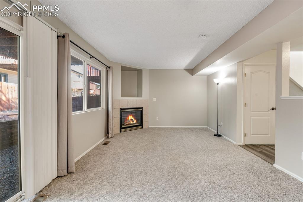 730 Mediterranean Point Colorado Springs, CO 80910 - Photo 8 of 30 a view of an empty room with a fireplace and a window