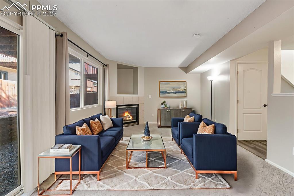 730 Mediterranean Point Colorado Springs, CO 80910 - Photo 9 of 30 a living room with furniture and a fireplace