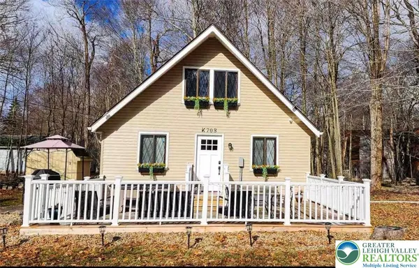 a view of a house with a yard and fence
