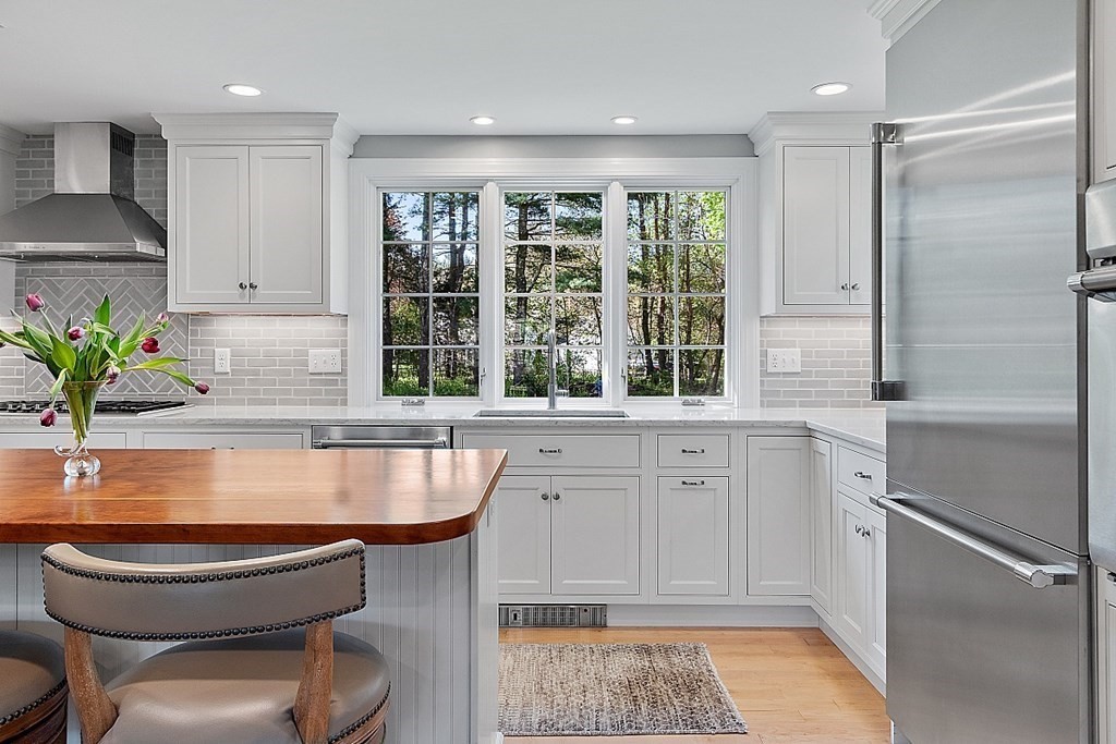 537 Barretts Mill Road Concord, MA 01742 - Photo 14 of 35 a kitchen with a stove a sink and a refrigerator