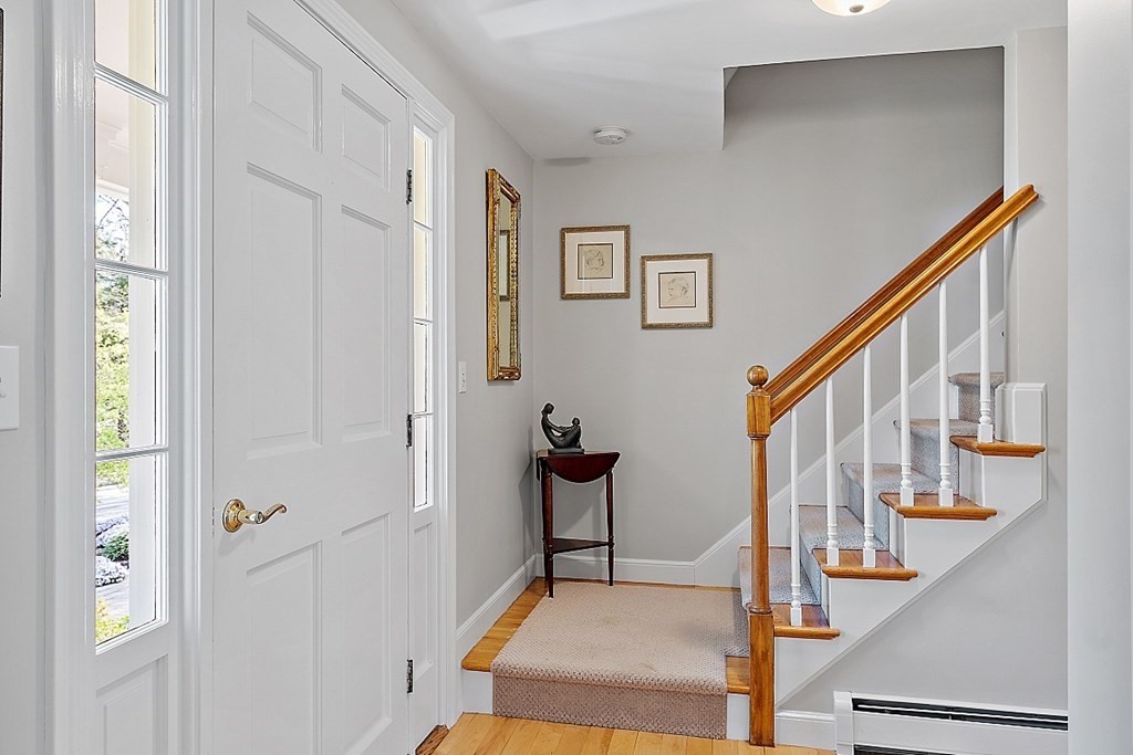 537 Barretts Mill Road Concord, MA 01742 - Photo 18 of 35 a view of staircase with lots of frames on wall and a window