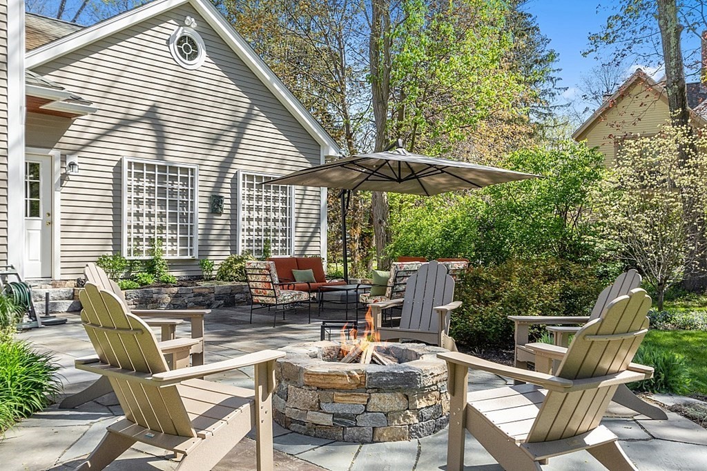 537 Barretts Mill Road Concord, MA 01742 - Photo 29 of 35 a view of a patio with a table and chairs under an umbrella