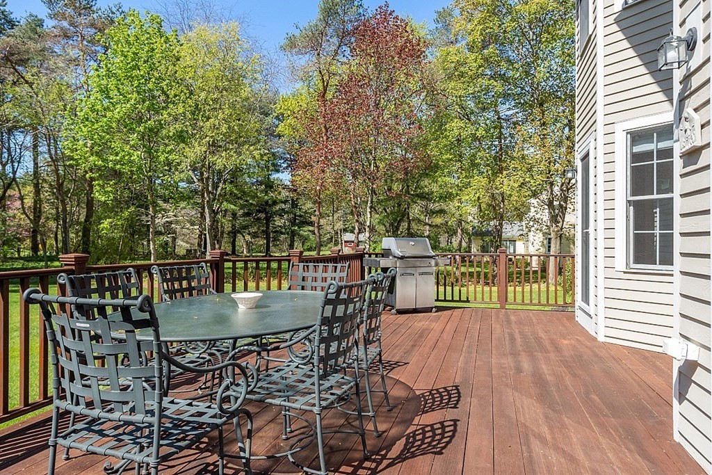537 Barretts Mill Road Concord, MA 01742 - Photo 32 of 35 a view of a balcony with table and chairs and wooden floor