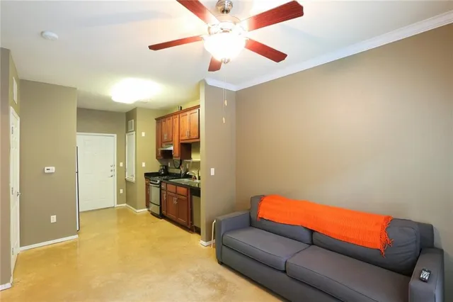 a living room with a couch and a ceiling fan