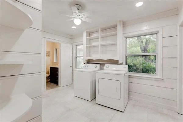 a room with white cabinets and stainless steel appliances