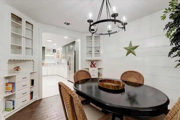 a dining room with furniture and wooden floor