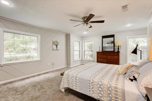 a bedroom with a large bed and a window