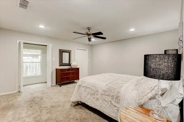 a bedroom with a bed and a couch
