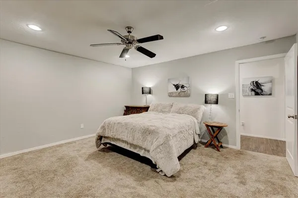 a spacious bedroom with a bed and a chandelier