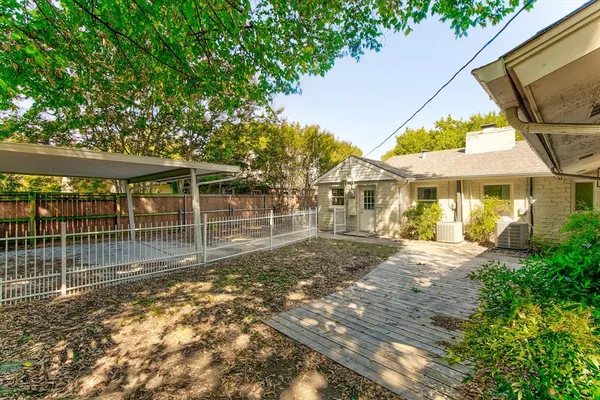 a view of a yard with a wooden fence