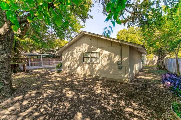 a backyard of a house with table and chairs