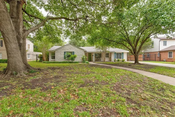 a house with green field in front of it