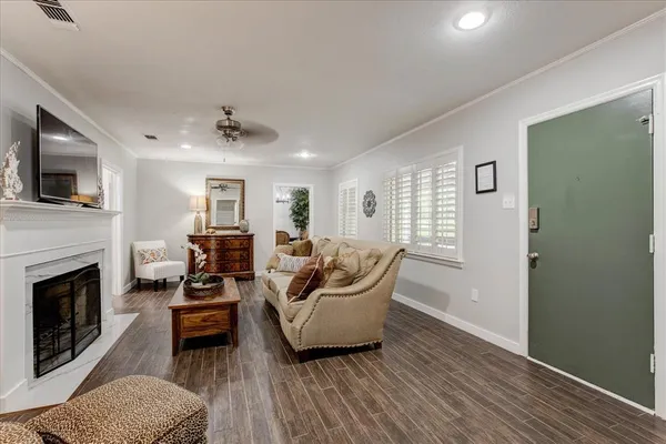 a living room with furniture a fireplace and a flat screen tv