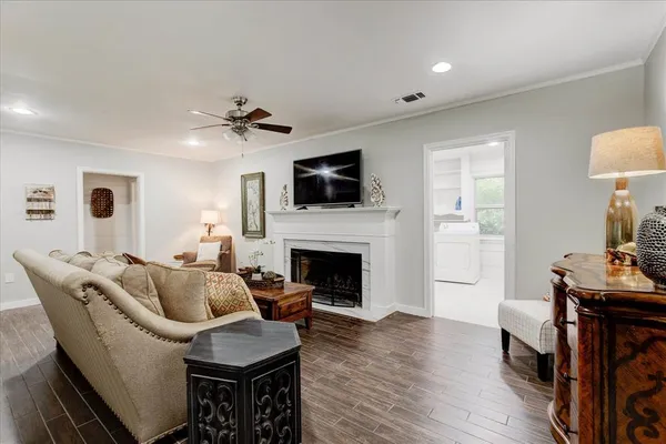 a living room with furniture a flat screen tv and a fireplace