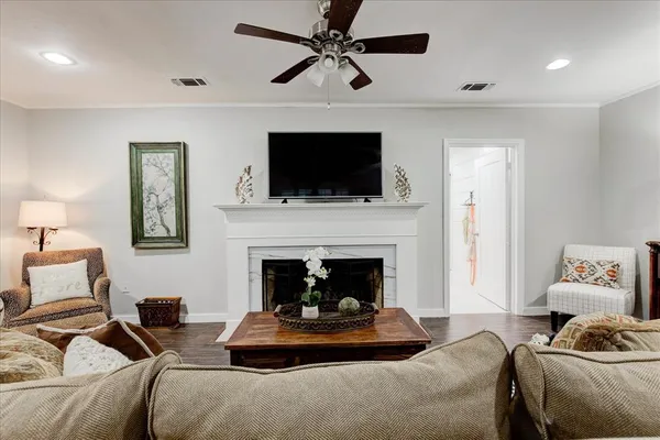a living room with furniture a flat screen tv and a fireplace