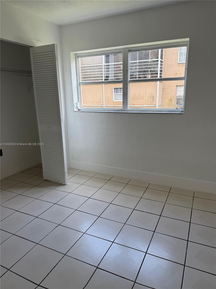 6625 West 4th Avenue, Unit 204 Hialeah, FL 33012 - Photo 5 of 11 an empty room with windows