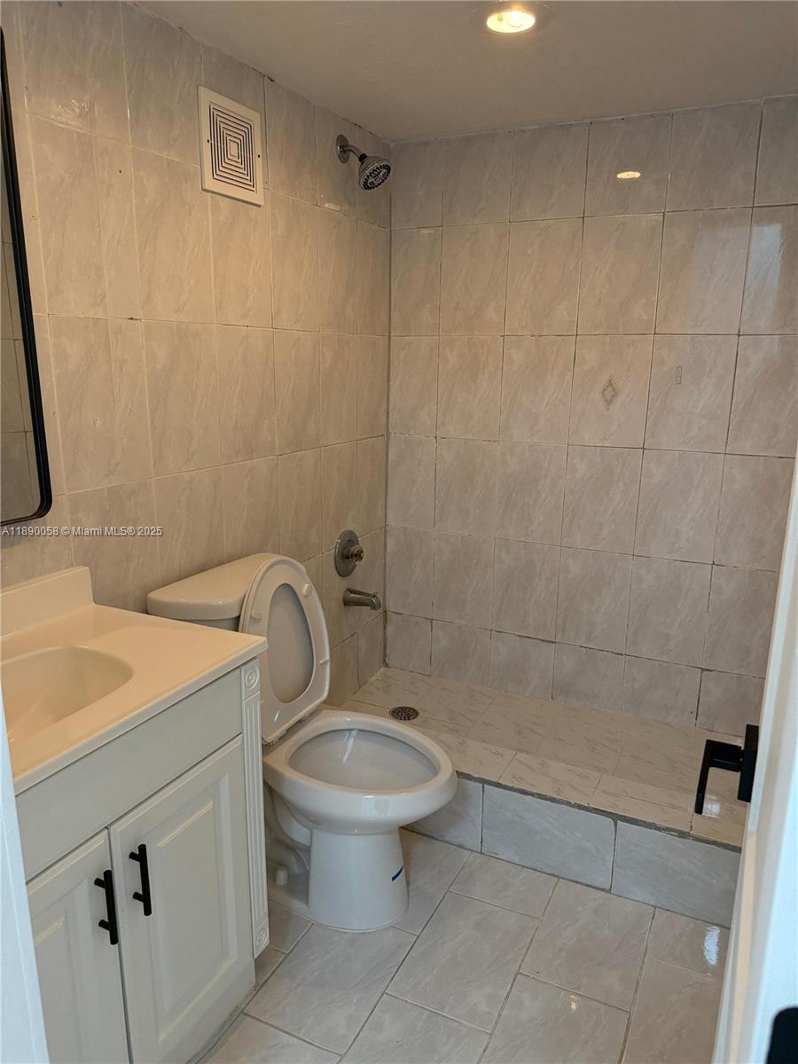6625 West 4th Avenue, Unit 204 Hialeah, FL 33012 - Photo 10 of 11 a bathroom with a sink a toilet and shower