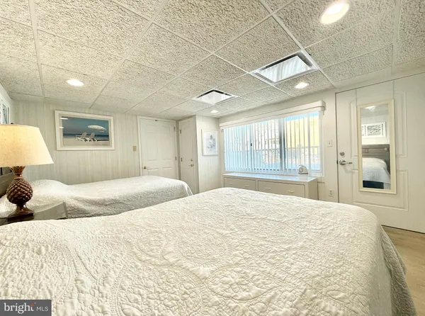 a bedroom with a large bed and a large window