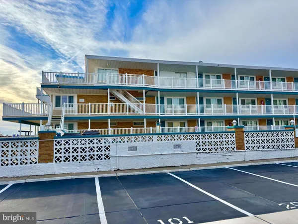 a view of a balcony with wooden floor and fence