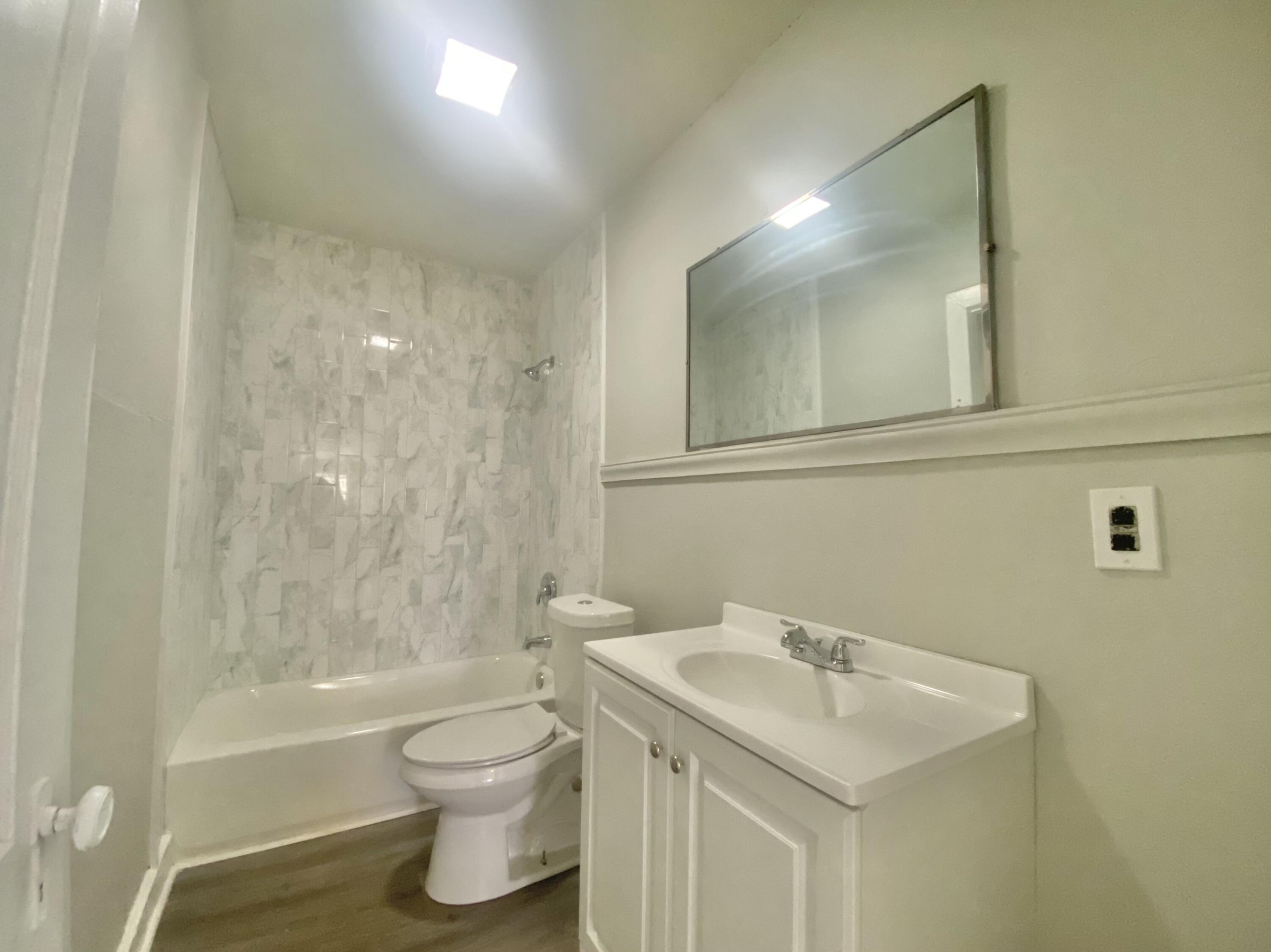 5701 45th Street Lubbock, TX 79414 - Photo 11 of 12 a bathroom with a sink a toilet and shower